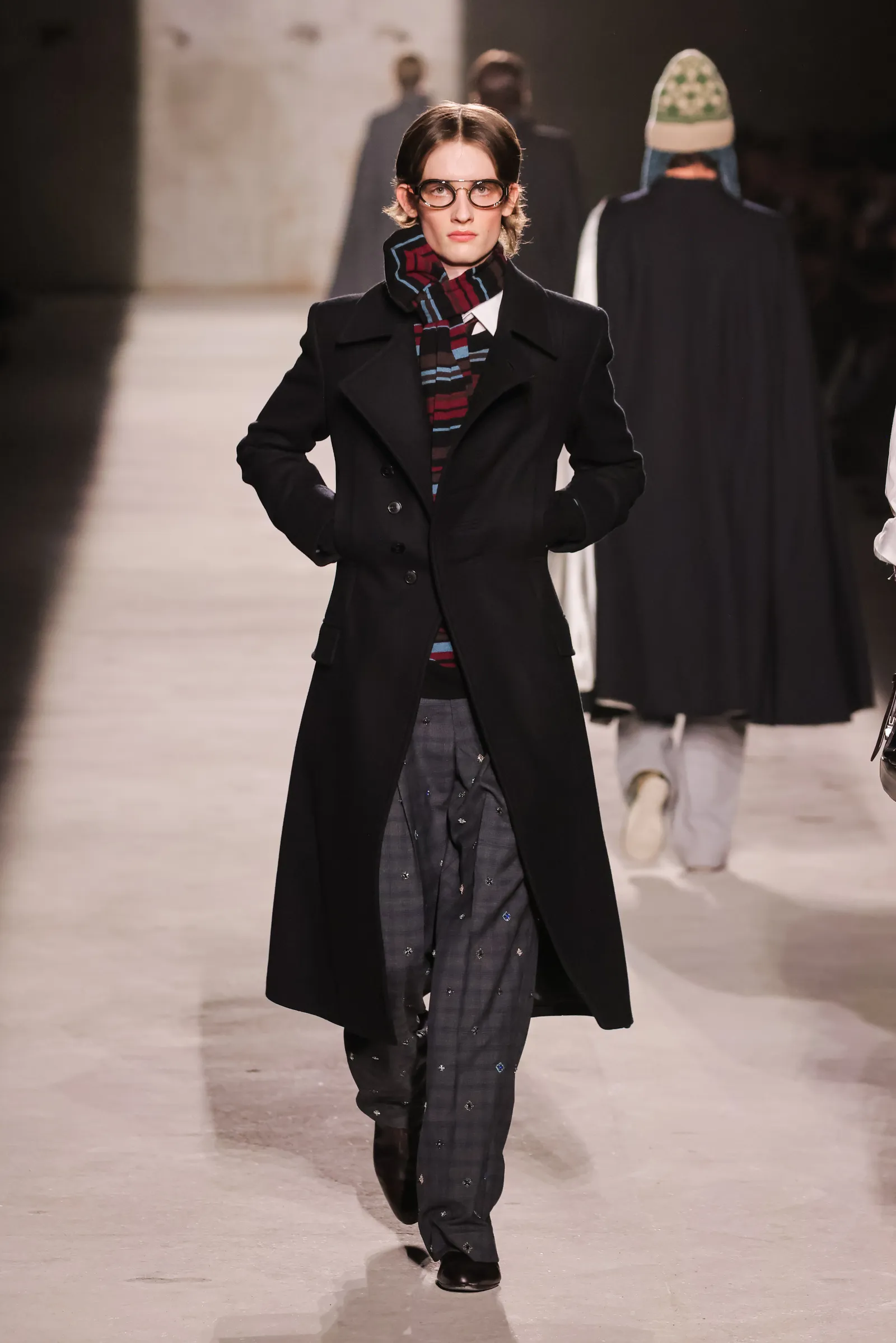 Image may contain Clothing Coat Overcoat Fashion Scarf Adult and Person