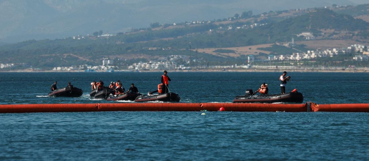 Die marokkanische Marine patrouilliert vor der schwimmenden Barriere zu Ceuta.